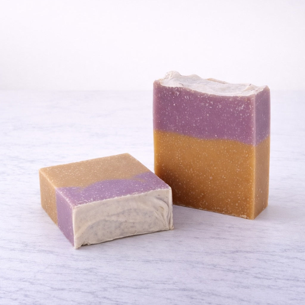 Two layered soap bars on a textured white surface