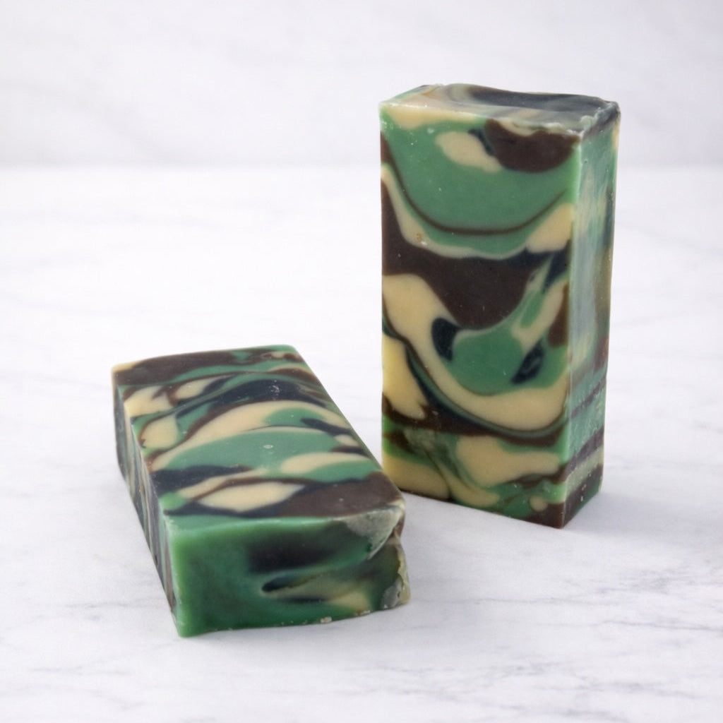 Two bars of camouflage-patterned soap on a white background