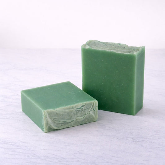 Two bars of green soap on white background.